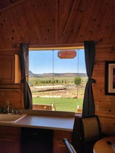 a window in a kitchen with a view of a field at Grandpa's Cabin in Apple Valley