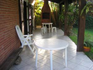 a white table and chairs on a patio at RIVIERA-CASA FAMILIAR PERTO DA PRAIA-3 QUARTOS-3 BANHEIROS-ATÉ 10 PESSOAS-Módulo 4 in Bertioga +28 photos