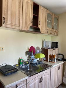 a kitchen with wooden cabinets and a sink and a counter at Apartment in a beach house Old town Nessebar in Nesebar