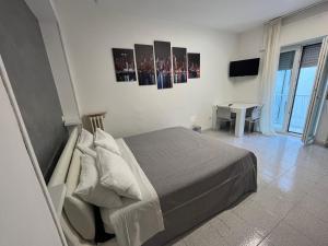 a bedroom with a bed and a desk and a television at D&V MAISON in Potenza