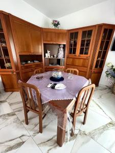 a kitchen with a table with a purple table cloth at Furore house of Benedetta in Furore