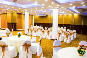 little rose inn في ويلاوايا: قاعة احتفالات بطاولات بيضاء وكراسي بيضاء