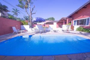 a large blue swimming pool in a yard at Nova, piscina exclusiva, 350 m. de Camburizinho in Camburi