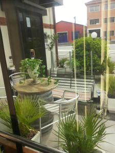a patio with chairs and tables and potted plants at Hotel Autoespresso Venice - Atika & Atif in Marghera