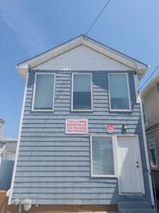 a blue house with a sign on the front of it at Shore Beach Houses - 40 - 1 Dupont Ave in Seaside Heights