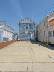 a gray building with a door in a parking lot at Shore Beach Houses - 40 - 1 Dupont Ave in Seaside Heights