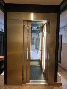 an elevator door in a building with a hallway at Piso NUEVO en centro de Madrid in Madrid