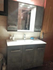 a bathroom with a sink and a mirror at Luxury Apartment in Dhamoulianáta