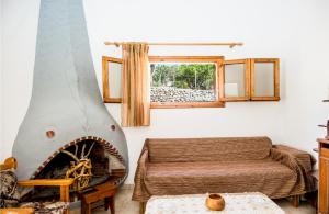 a living room with a fireplace and a bed at Tzatzaminia Cottage in Argostoli