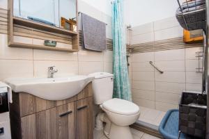 a bathroom with a sink and a toilet at Tzatzaminia Cottage in Argostoli