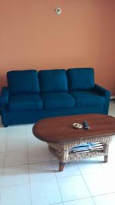 a blue couch in a living room with a coffee table at Luxury Condo Special beach onsite in Montego Bay