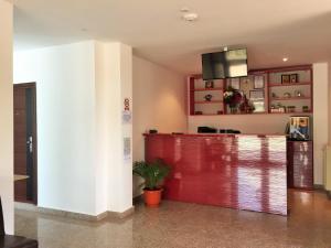 a lobby with a red counter in a building at Hotel Mihaela in Mamaia
