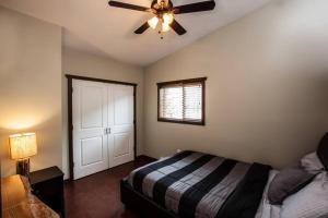 a bedroom with a bed and a ceiling fan at The best 2 bedrooms suite in Revelstoke! in Revelstoke