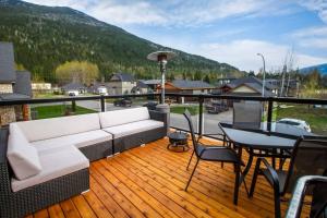 a porch with a couch and a table on a deck at The best 2 bedrooms suite in Revelstoke! in Revelstoke