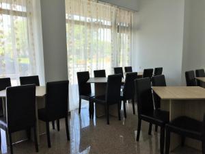 a conference room with tables and chairs and windows at Hotel Mihaela in Mamaia