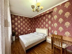 a bedroom with a bed and a chandelier at Hostel 4U in Bishkek