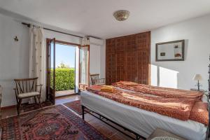 ein Schlafzimmer mit einem Bett und einem großen Fenster in der Unterkunft Villa Lobo in Salobreña