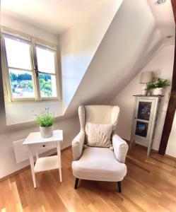 a living room with a chair and a table at Dobré časy - Studio II in Banská Štiavnica