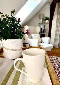 a coffee cup sitting on a table in a living room at Dobré časy - Studio II in Banská Štiavnica