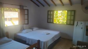 Tempat tidur dalam kamar di Pousada João e Maria