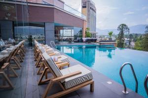 a hotel with a swimming pool with lounge chairs at Hotel Barahi Kathmandu in Kathmandu