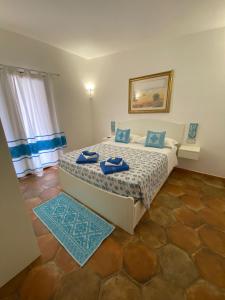 a bedroom with a bed with blue towels on it at Tenute Efis in Galtellì