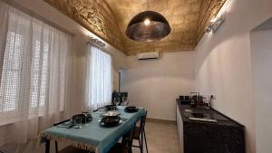 a kitchen with a table with a blue table cloth at Murat48 in Bari