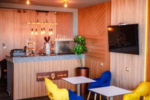 a restaurant with two tables and a bar at Hotel Vents Des Iles in Essaouira