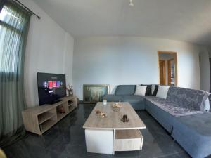 a living room with a couch and a table at Alternative Lux Apartment in Dhamoulianáta