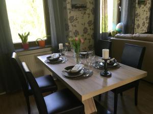 a dining room table with plates and candles on it at Zur alten Zahnradbahn in Sankt Andreasberg