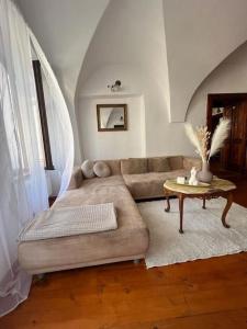 a living room with a couch and a table at City Center Apartment in Banská Bystrica