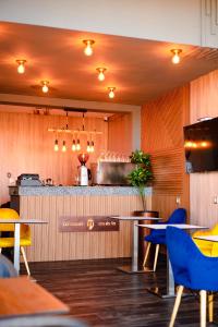 a restaurant with tables and chairs and a bar at Hotel Vents Des Iles in Essaouira