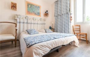 a bedroom with a bed and a chair and a window at 2 Bedroom Gorgeous Home In Jonquires St Vincent in Jonquières-et-Saint-Vincent