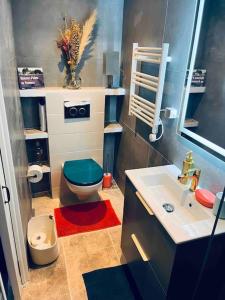 a small bathroom with a toilet and a sink at Triplex de Saint-Paul Free public parking in Saint-Paul-de-Vence