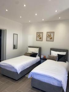 two beds sitting next to each other in a room at Studio apartment Lu in Rupa