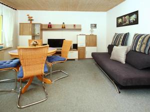 a living room with a couch and a table at holiday home, Plau am See in Plau am See