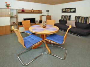a living room with a table and chairs and a couch at holiday home, Plau am See in Plau am See