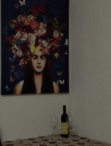 a painting of a woman withwine glasses on a table at Apartman Stasija in Tivat