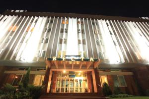 a large building with a lit up facade at night at Hotel Vesta in Brest