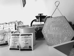 a counter top with products and a sign that says bee happy at Studio apartment within city centre with ensuite in Coventry