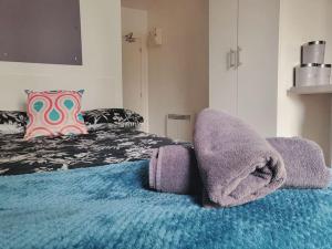 a bedroom with a bed with towels on it at Studio apartment within city centre with ensuite in Coventry
