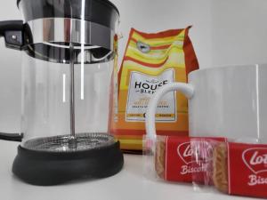 a blender next to a bag of food and a coffee mug at Studio apartment within city centre with ensuite in Coventry