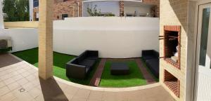 a living area with a couch and grass in a house at A Family house in Santa Cruz, Torres Vedras in Silveira