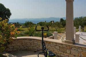 a bike parked on a stone retaining wall at House Blato in Postira