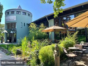 a building with a lighthouse in the middle of a garden at Kvartier2 in TOP-Lage, 5 min zur Bali-Therme und GOP, HDZ, Arbeitsplatz, Boxspringbett in Bad Oeynhausen