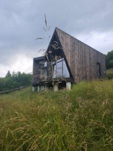 a barn sitting on top of a grassy field at CloudBase in Tukhlya