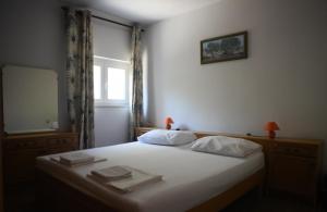 a bedroom with a bed with a mirror and a window at Garden Apartment Braut in Kornić