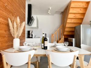 a dining room with a white table and chairs at Villa Baltica in Niechorze