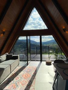 a living room with a large window with a view at Mirador Cottage in Slavske