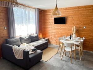 a living room with a couch and a table at Villa Baltica in Niechorze